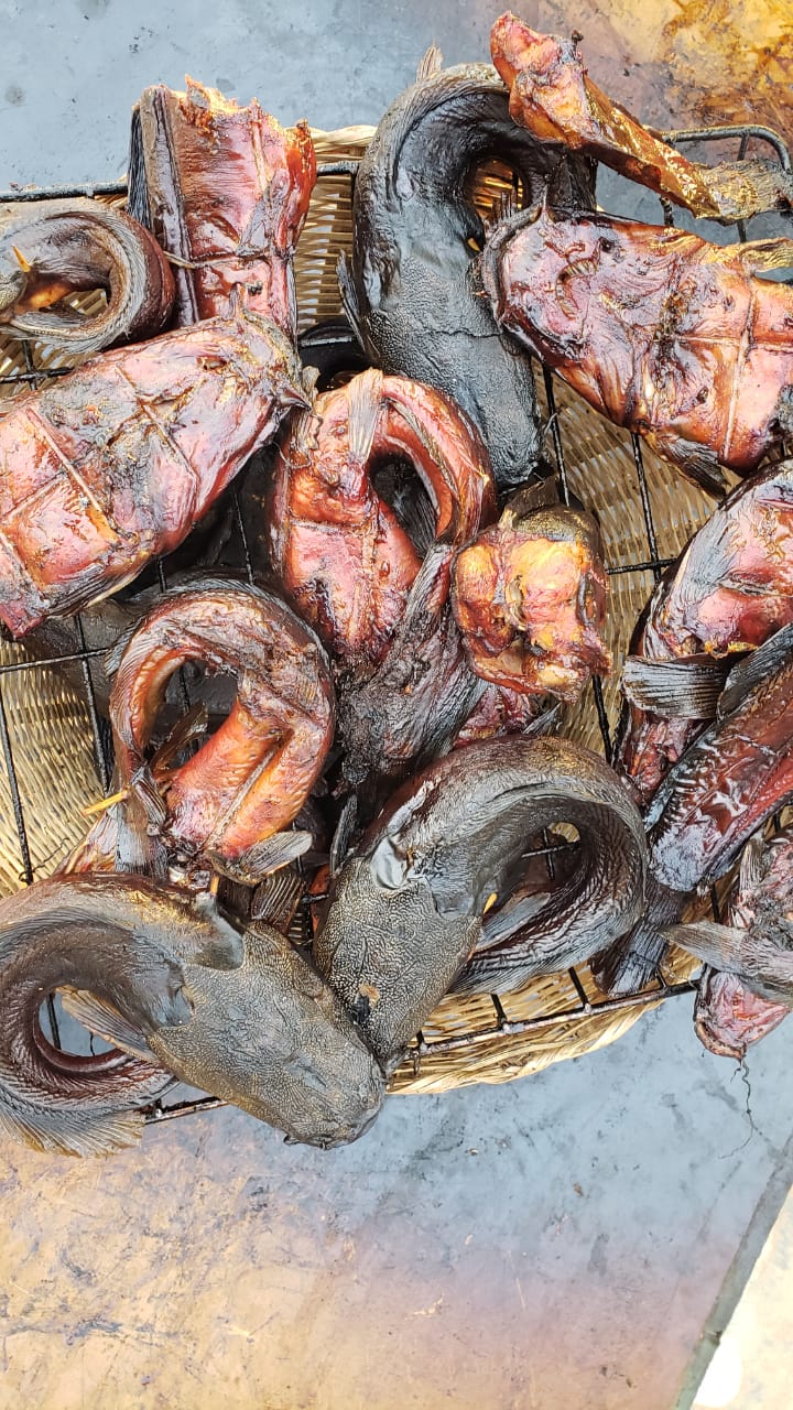 Closely packed smoked fish in a market display